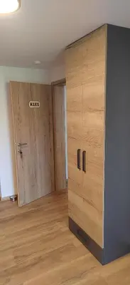 a room with two wooden cabinets and a door at MaxLux Apartments in Slovenj Gradec