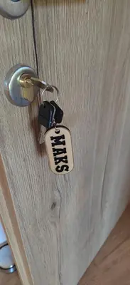 a lock on a door with a tag on it at MaxLux Apartments in Slovenj Gradec