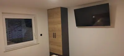 a room with a flat screen tv and a window at MaxLux Apartments in Slovenj Gradec