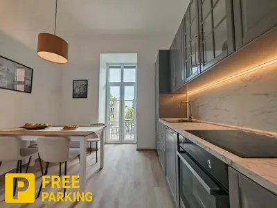 a kitchen with a sink and a dining table at Mabo apartments - Ljubljana in Ljubljana