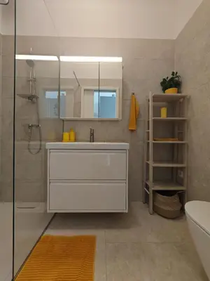 a bathroom with a white sink and a shower at Mabo apartments - Ljubljana in Ljubljana