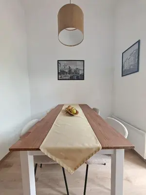 a dining room table with a napkin on top of it at Mabo apartments - Ljubljana in Ljubljana