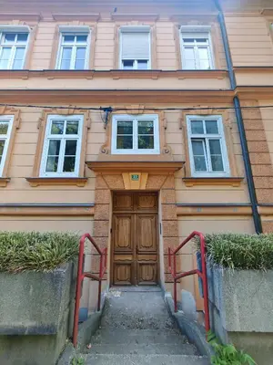 a house with a wooden door in front of it at Mabo apartments - Ljubljana in Ljubljana