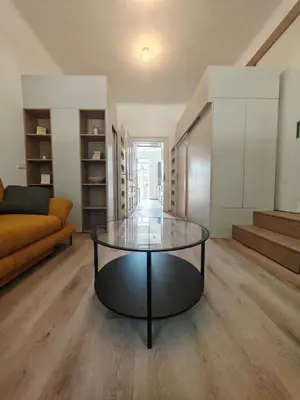 a living room with a glass table in the middle at Mabo apartments - Ljubljana in Ljubljana