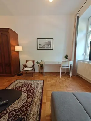 a living room with a couch and a table at Mabo apartments - Ljubljana in Ljubljana
