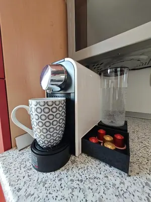 a coffee maker sitting on a counter with a cup at Mabo apartments - Ljubljana in Ljubljana