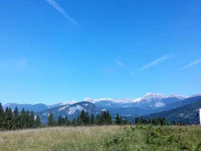 a view of a mountain range with snow capped mountains at Apartments Timjana in Bohinj