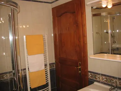 a bathroom with a shower and a wooden door at Apartments Timjana in Bohinj
