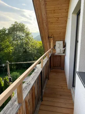 a balcony of a house with a wooden railing at Apartma Klemenc in Bohinj