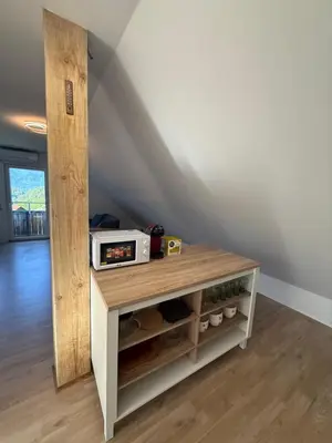 a room with a table with a microwave on it at Apartma Klemenc in Bohinj