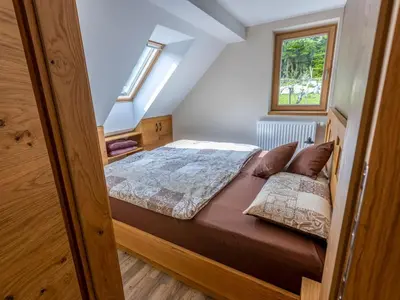 a small bedroom with a bed in a attic at Villa Taja