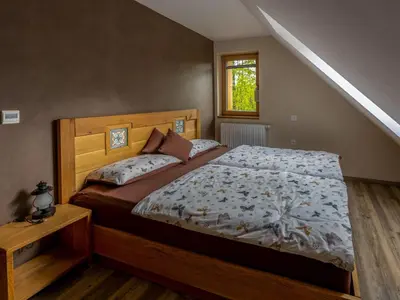 a bedroom with a bed with a wooden head board at Villa Taja