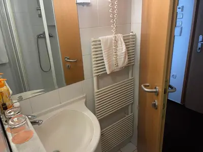 a bathroom with a sink and a toilet and a mirror at hotel Diana in Murska Sobota