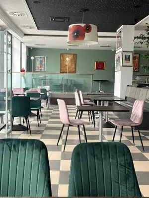 a dining room with chairs and a table and a table and chairs at hotel Diana in Murska Sobota