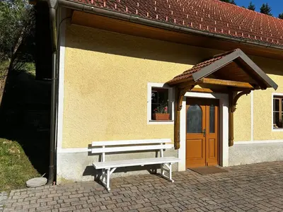 a bench sitting in front of a building at The Little Fern Apartment in Rovte