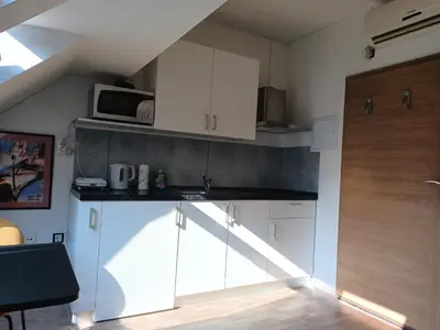 a kitchen with white cabinets and a microwave at Apartment Simon in Škofja Loka