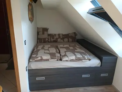 a bed in the corner of a room at Apartment Simon in Škofja Loka