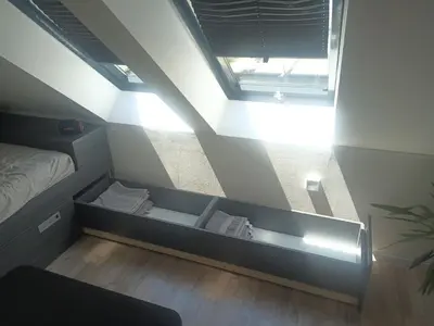 a small room with a bed and a ceiling at Apartment Simon in Škofja Loka