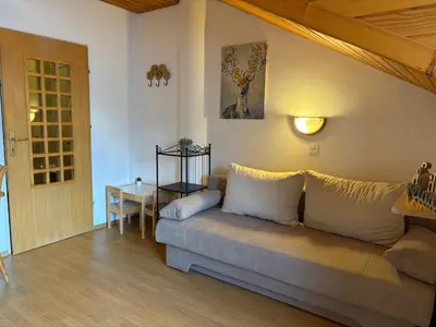 a living room with a couch and a table at Alpine Sun apartment in Kranjska Gora