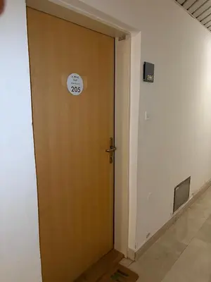 a door with a clock on it in a hallway at Alpine Sun apartment in Kranjska Gora