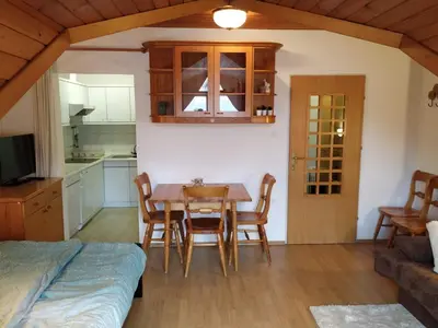 a kitchen and dining room with a table and chairs at Alpine Sun apartment in Kranjska Gora