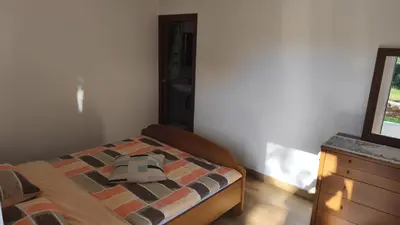 a bedroom with a bed with a hat on it at Sobe Godina in Materija