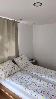 a bed with colorful pillows on top of it at Sobe Godina in Materija