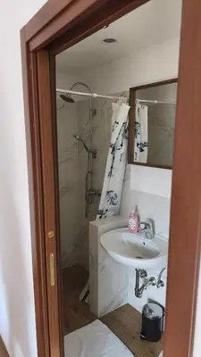 a bathroom with a sink and a shower at Sobe Godina in Materija