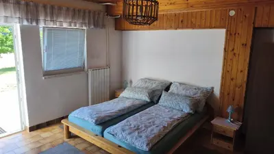 a bedroom with a bed in a room with a window at Sobe Godina in Materija