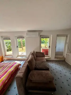 a living room with a couch and a bed at Božič Residence in Vipava