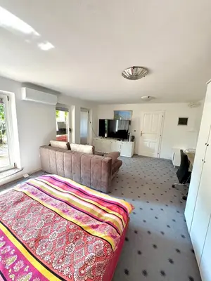 a living room with a couch and a tv in it at Božič Residence in Vipava