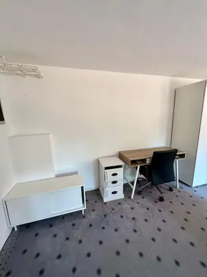 an empty office with a desk and a desk and a table at Božič Residence in Vipava