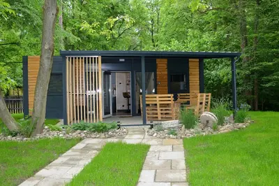 a small cabin in the middle of a garden at Emina Hiška in Braslovče