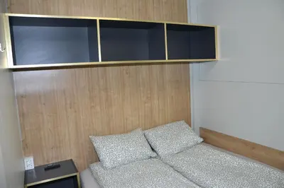 a small room with a couch and a cabinet at Emina Hiška in Braslovče