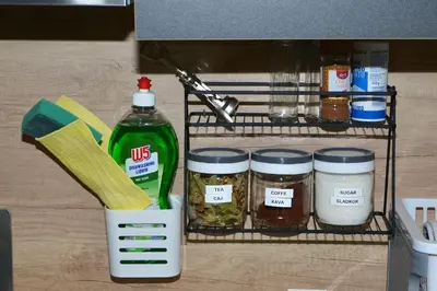 a shelf with jars of food and a bottle at Emina Hiška in Braslovče