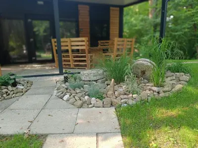 a garden with rocks and plants in front of a house at Emina Hiška in Braslovče