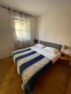 a bedroom with two beds and a window at Terme Čatež apartma Solist