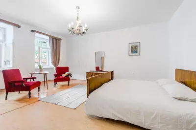 a bedroom with a bed and a table and chairs at Hiša Vuga in Tolmin