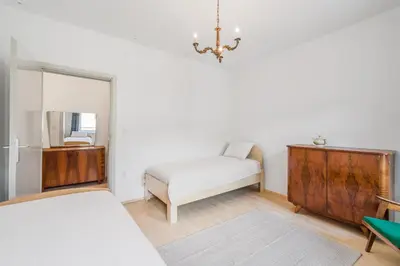 a bedroom with a bed and a dresser and a mirror at Hiša Vuga in Tolmin