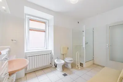 a bathroom with a toilet and a shower and a sink at Hiša Vuga in Tolmin