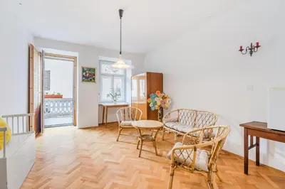 a kitchen and living room with a table and chairs at Hiša Vuga in Tolmin