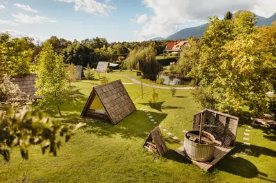 a garden with a chicken coop and a fence at Glamping Bizjak in Preddvor