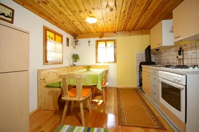 a kitchen with a table and a small table in it at Turistična kmetija Povh in Prevalje