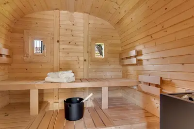a wooden sauna with a trash can in it at Mirola homes - rent in nature in Zagorje ob Savi