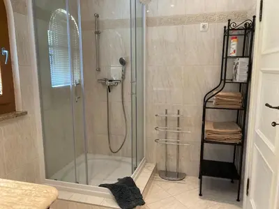 a shower with a glass shower stall in a bathroom at Vila Gradisca in Gradišča