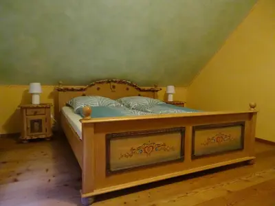 a bedroom with a bed with a wooden frame at Vila Gradisca in Gradišča