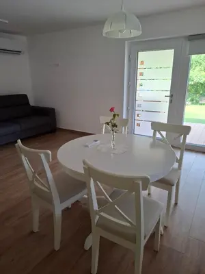 a white table and chairs in a living room at Apartments Serafina in Tolmin