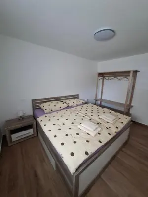 a bedroom with a bed and a nightstand and a bed sidx sidx sidx sidx at Apartments Serafina in Tolmin