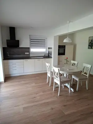 a kitchen and dining room with a table and chairs at Apartments Serafina in Tolmin