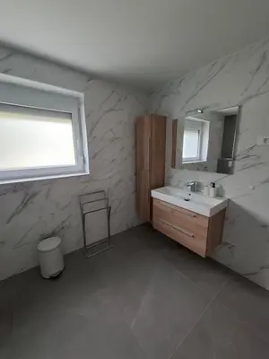 a bathroom with a sink and a mirror at Apartments Serafina in Tolmin